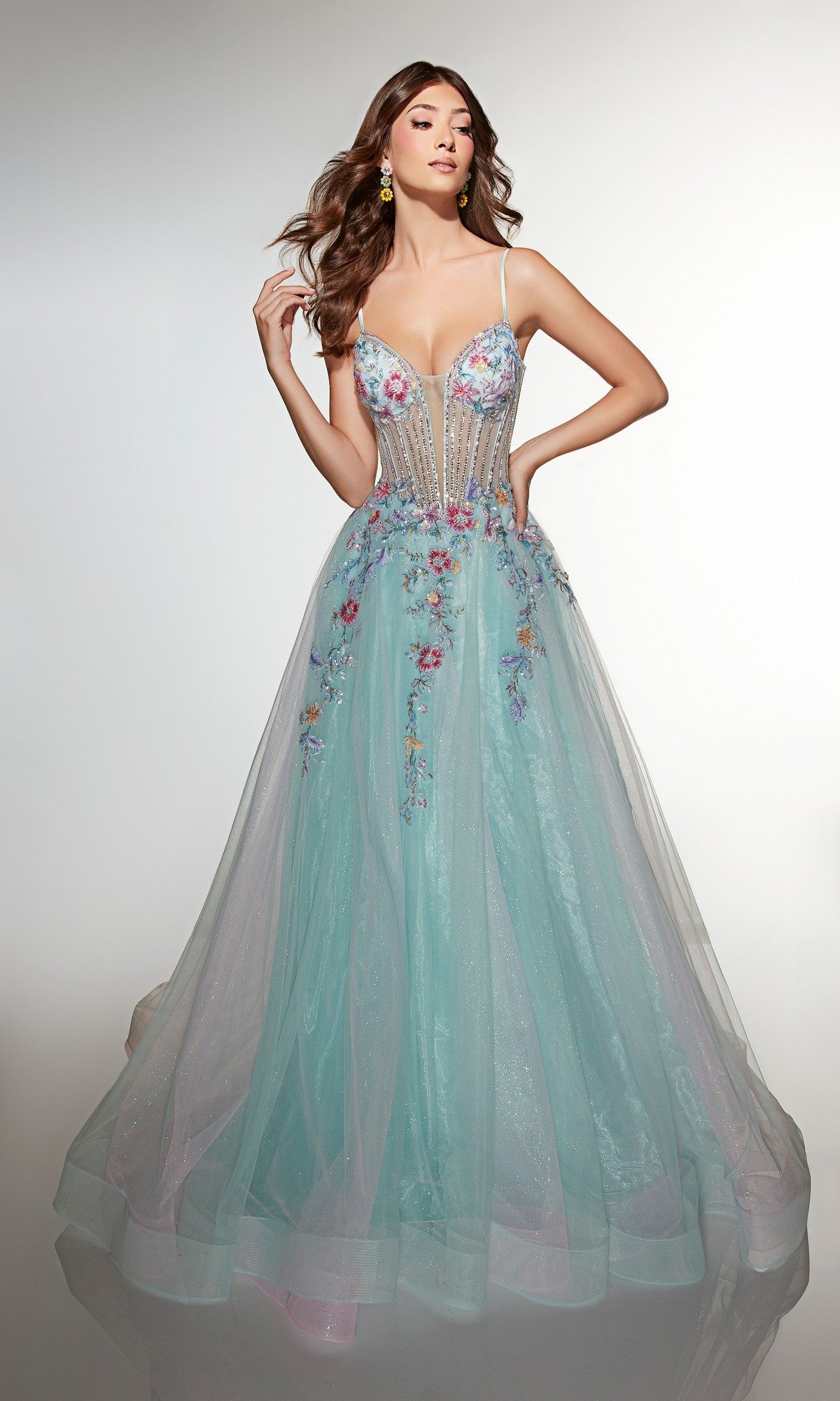 A woman in the Alyce 62068 long prom dress, featuring a sleeveless design, sparkling A-line tulle skirt, and floral embroidered sheer bodice, poses against a plain light background.